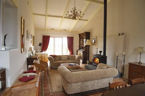 very large, comfortable sitting room with Jotul woodburner and large glazed doors leading to terrace