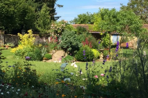 Rear garden in summer as seen from terrace outside large lounge