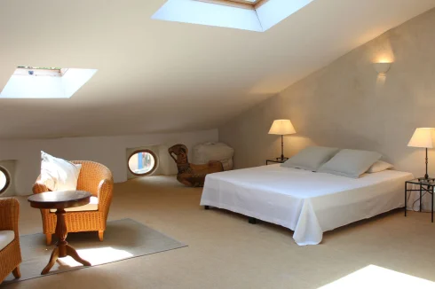 Bedroom 1 overlooking the 'Place' with 'oil de boeuf' and Velux windows with electric blinds.