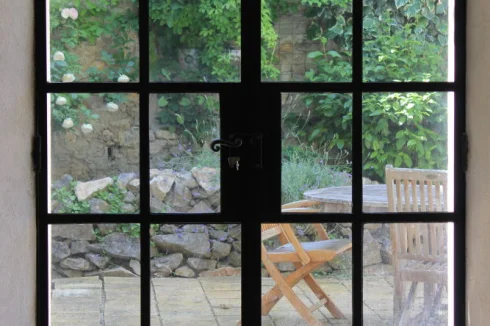 The metal framed, double glazed double door leading from the dinning room to the courtyard.