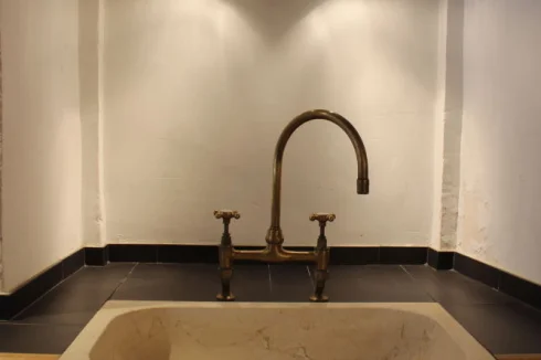 One of two Spanish stone kitchen sinks with solid brass taps from the UK