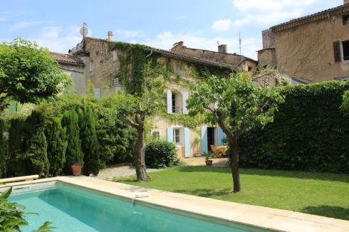 View of the back of the house and courtyard from the far side of the pool.