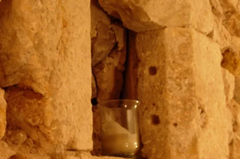 A stone window (c.1530) discovered during renovation work with holes for metal security bars.