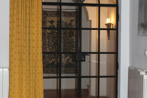 The metal framed door leading from the Salon to the first floor landing