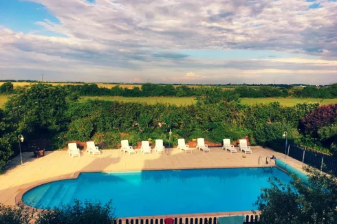 View over the swimming pool the grounds and to the countryside beyond