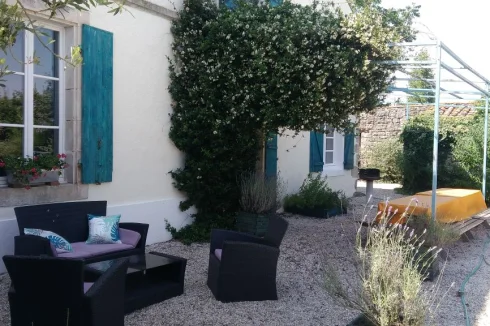 Les Boulins (sleeps 10) poolside terrace with tables, bbq and comfortable seating