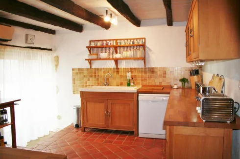 Main house kitchen with patio doors to pool