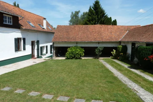 The modern extension, barn, outbuildings and front garden