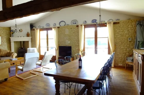 Salon and dining barn with wood burner and French windows on to balcony