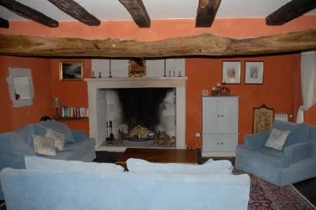 Sitting room with 17th century fireplace and original medieval oak floor