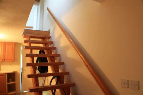 Stairs leading up towards bedrooms