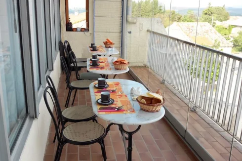 Breakfast terrace with sliding glass wall and second window giving 180 degree views