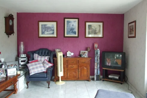 Half of large living area, two windows and French doors make it bright and airy.