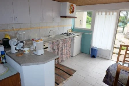 Kitchen in gite. Fridge and hob, double sink, cupboards