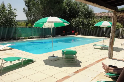 enclosed 10m pool with wide terraced surround and covered areas