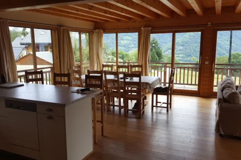 Open plan living area with automatic blinds on exterior and silk curtains interior