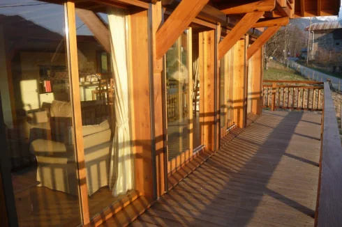 Main balcony south facing with automatic shutters and brass up/downlights to whole chalet