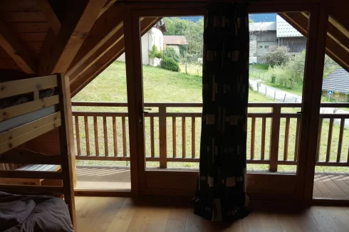 Bunk room with balcony facing east, central curtain