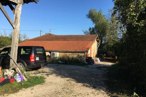 The parking area and front of the house with new roof