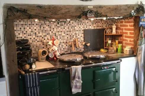 The fireplace in the kitchen is perfect for housing a large cooker, and the Aga is included!